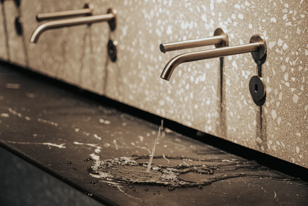 The Splash Lab faucet in commercial washroom running water
